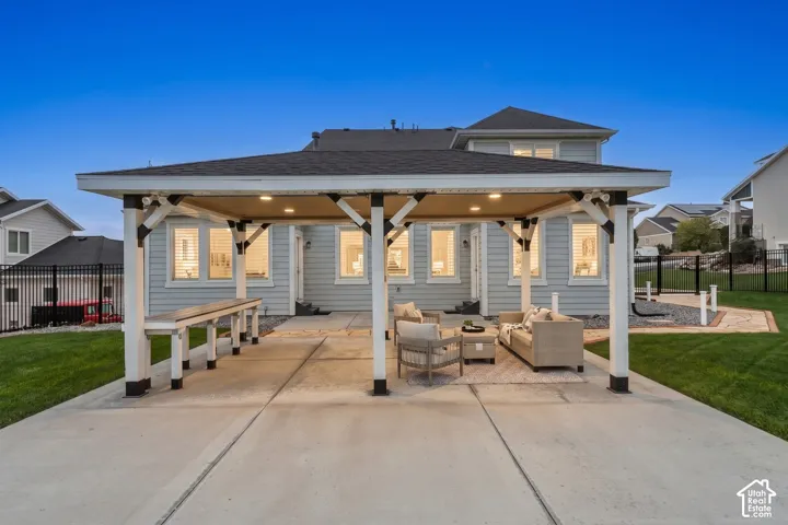 Covered patio featuring a built-in bar, recessed lighting, concrete flooring, and horizontal siding