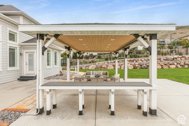 Covered outdoor structure featuring a wood-finish ceiling, recessed lighting, and a built-in counter, situated on a concrete patio
