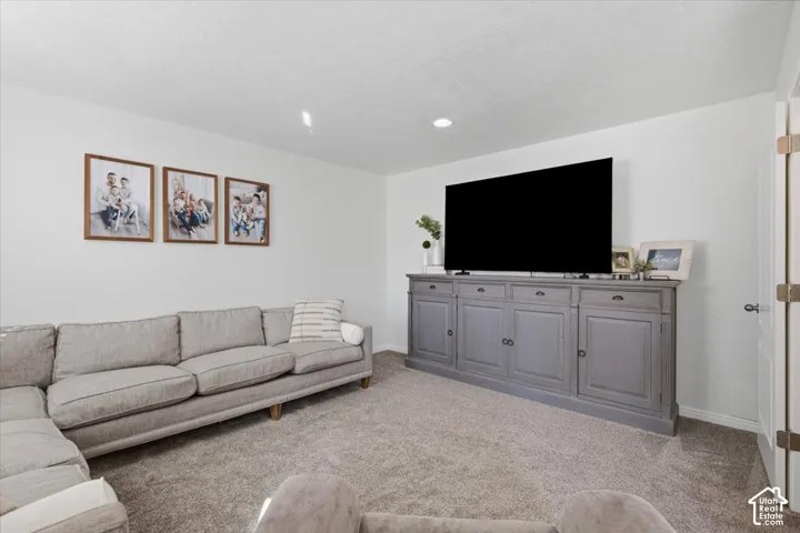 Interior space featuring neutral wall tones, recessed lighting, and wall-to-wall carpeting