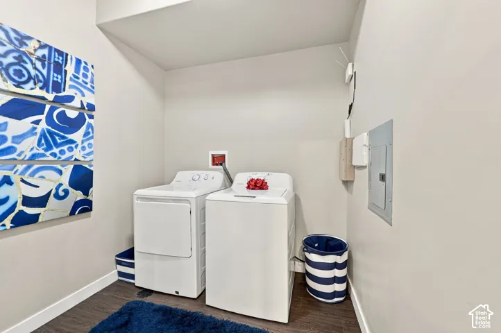 Laundry area featuring wood-finish flooring and an integrated electrical service panel
