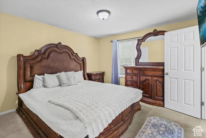 Neutral-toned room featuring a window with integrated blinds, flush-mount lighting, and a six-panel door