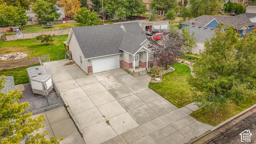 Single-story residence featuring an asphalt shingle roof, brick and horizontal siding exterior, attached two-car garage, concrete driveway, and landscaped front yard
