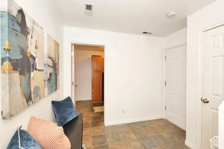 Interior foyer featuring multi-tonal tile flooring and a six-panel door