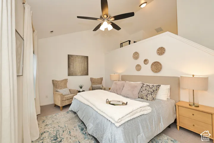 Vaulted ceilings featuring a central overhead fan with integrated lighting