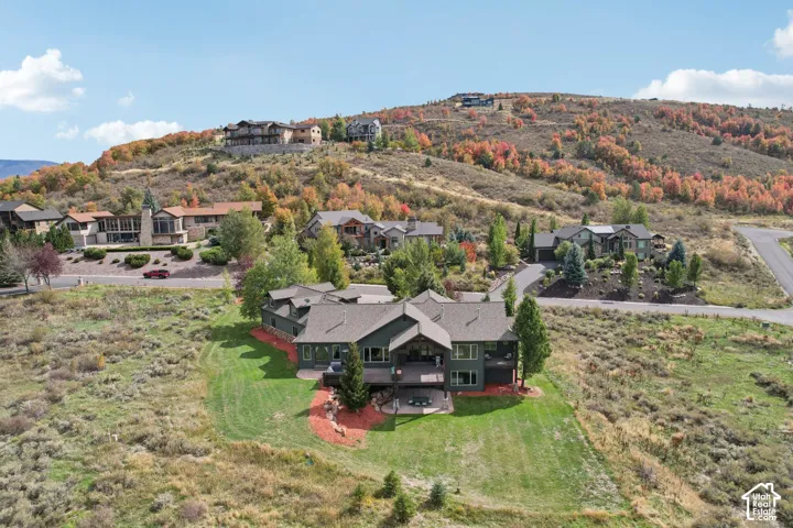 Multi-level residence featuring a dark-toned exterior, multiple gables, and a prominent deck