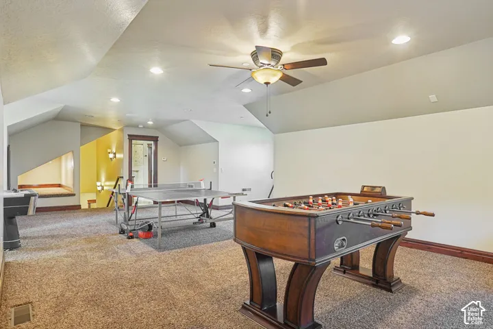 Spacious bonus room featuring vaulted ceilings, recessed lighting, a ceiling fan, and carpeted flooring