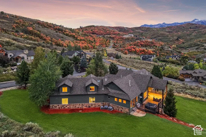 Expansive property featuring a multi-level exterior, an elevated outdoor living area, and a lower-level stone facade