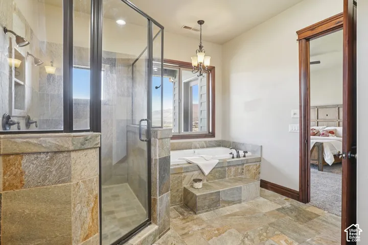 Walk-in shower with clear glass enclosure and dual showerheads