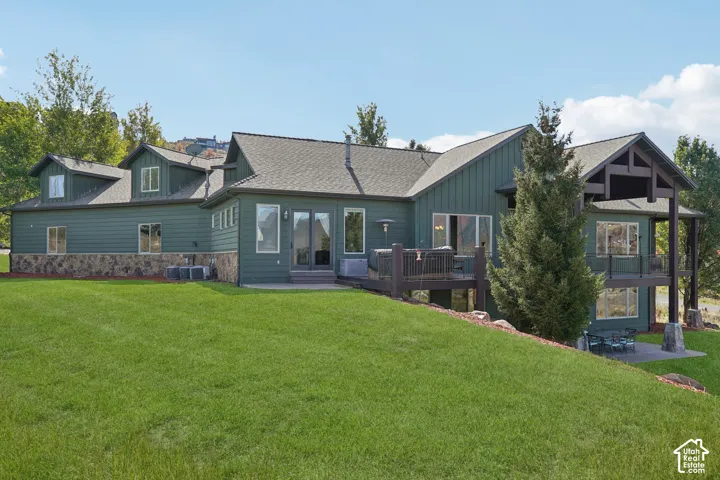 Multi-level exterior with board and batten siding and stone accents