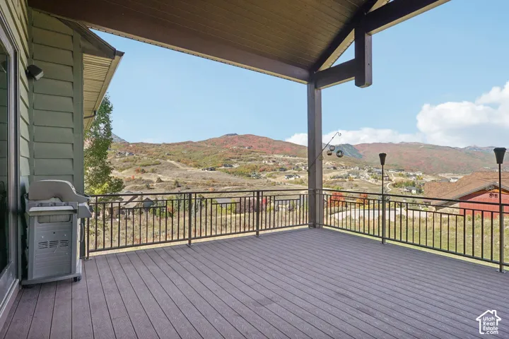 Covered outdoor deck with composite decking and black metal railing