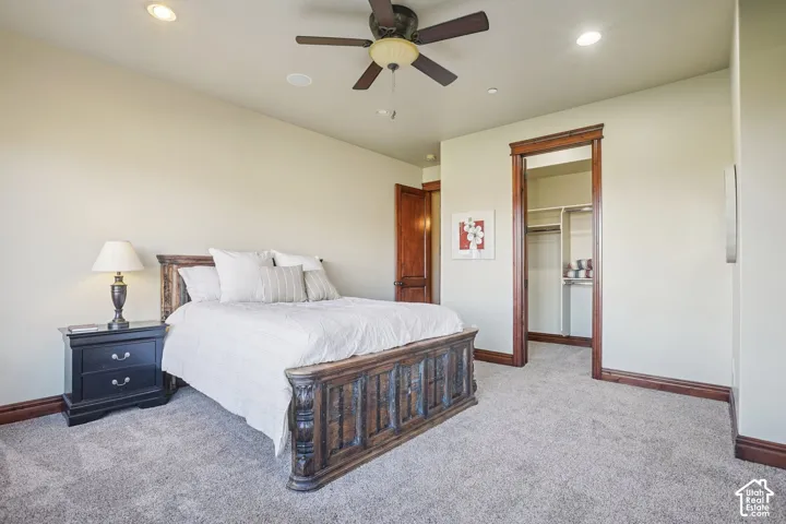 Recessed lighting, ceiling fan, wood-finish trim, wood-finish door, and carpet flooring