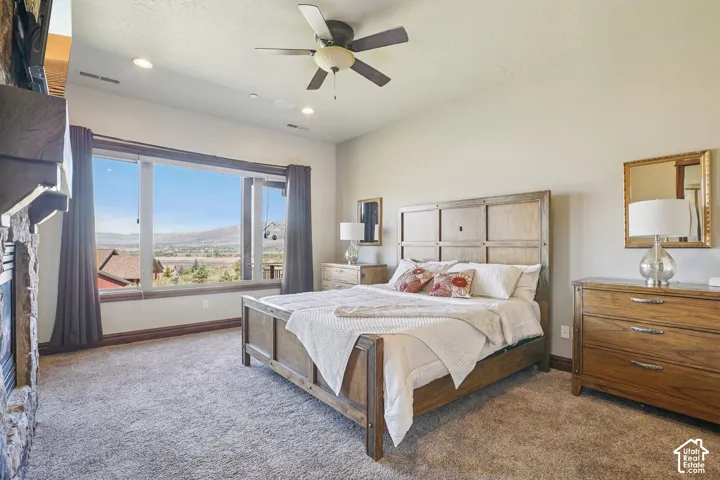 Wall-to-wall carpeting with a large window overlooking scenery