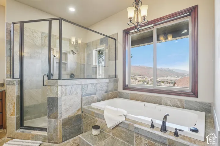 Walk-in shower with clear glass enclosure and tile surround