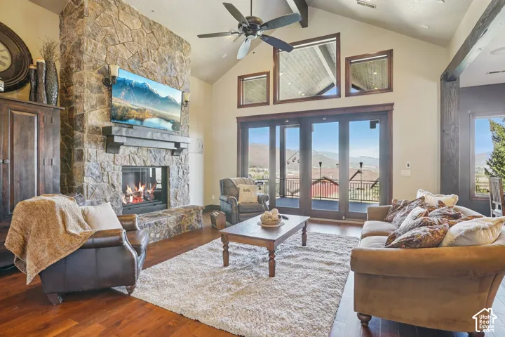 Vaulted ceiling featuring exposed wood beams and a ceiling fan