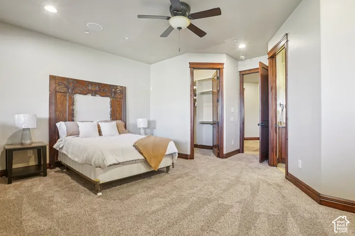 Recessed ceiling lighting, ceiling fan, warm-toned carpeting, and wood-trimmed doorways