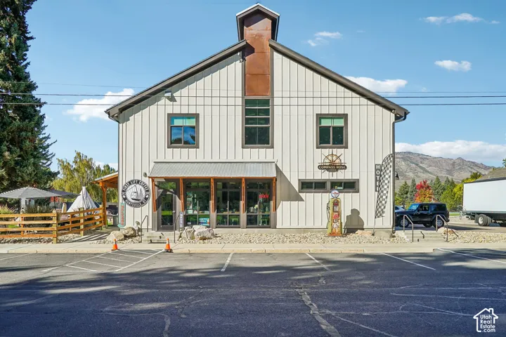 Commercial building with board-and-batten siding, a metal roof, and a prominent cupola