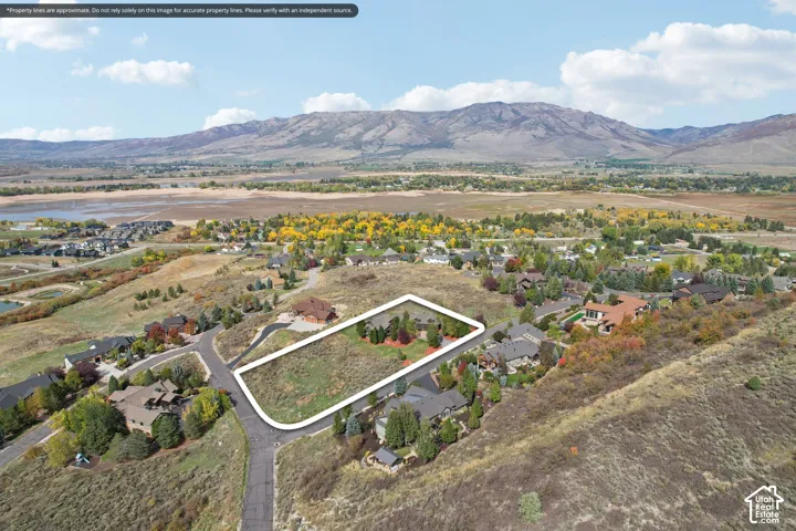 Expansive undeveloped lot featuring a natural landscape and surrounding mountainous terrain