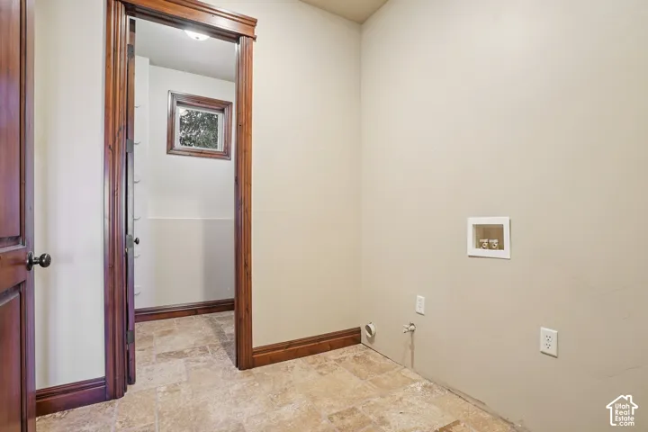 Tiled flooring, wood-finish door frames, and a visible electrical outlet