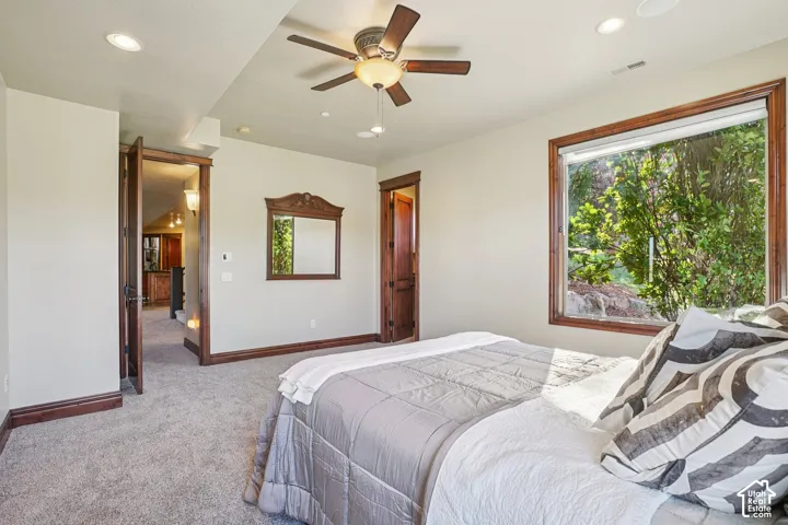 Recessed lighting, wood-trim window, ceiling fan with light, wood-trim doorway, and wall-to-wall carpeting