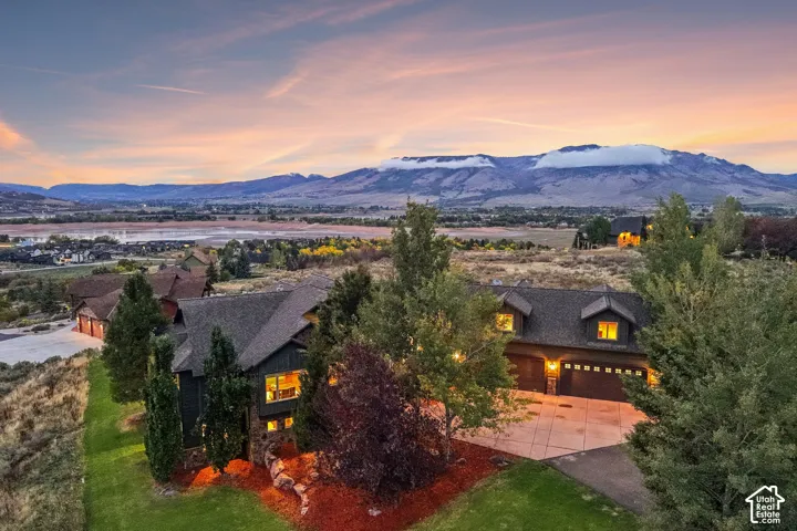 Contemporary home with multiple gables, stone accents, and a multi-car garage