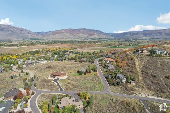 Expansive mountain landscape with scattered residential properties and paved roads