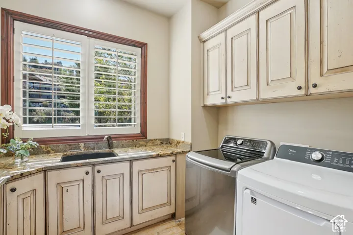 Plantation shutters, built-in cabinetry, granite-style countertop, undermount sink, and wood-trim window