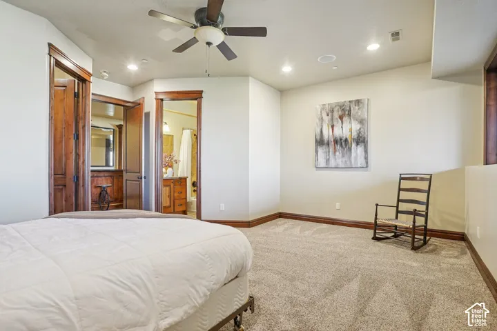 Expansive carpeted room with a ceiling fan, recessed lighting, and wood-finish trim