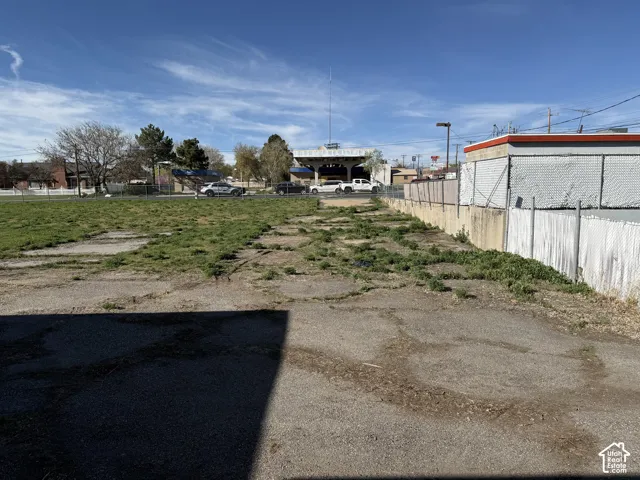 Level lot featuring paved surfacing and perimeter chain-link fencing