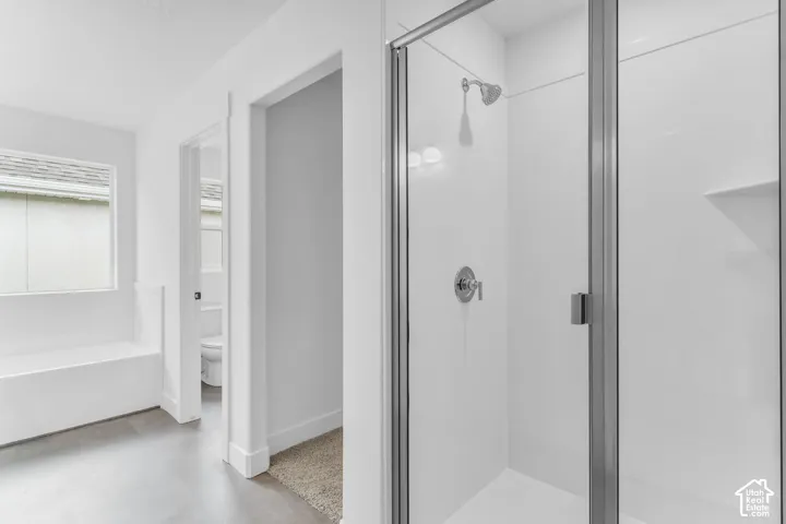 Primary bath with soaker tub and walk-in closet.