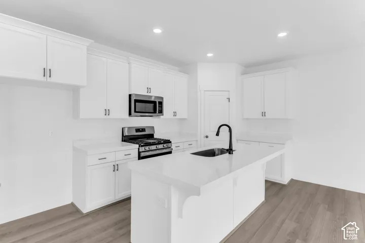 Terrific kitchen with 42" uppers, painted white wood cabinets, quartz slab countertops, gas range, dishwasher, microwave and disposal.