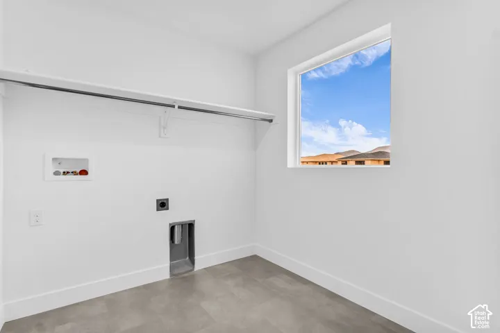 Full-size, dedicated laundry room with natural light and washer/dryer hookups.