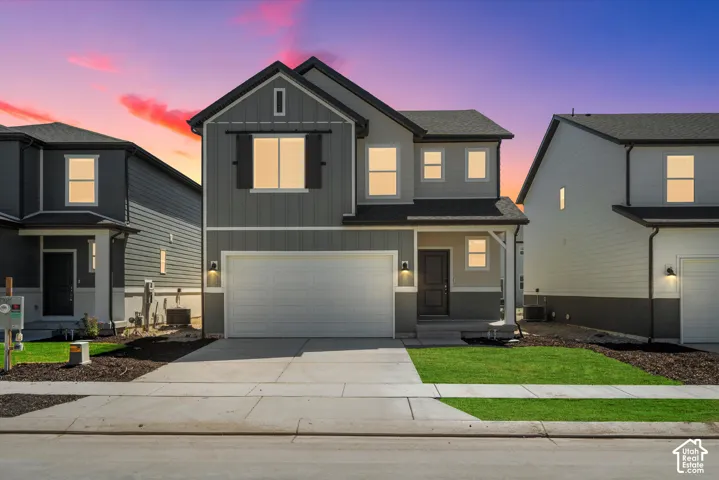 Two-story exterior featuring board-and-batten siding, horizontal lap siding, barn-style decorative window shutters, a front-facing attached two-car garage, and a covered entryway