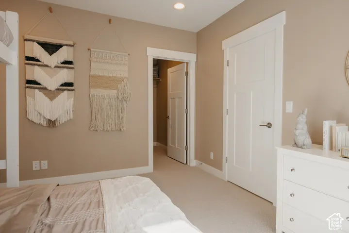 Neutral wall palette with white-finished trim, solid-core interior doors, recessed lighting, and wall-to-wall carpeting