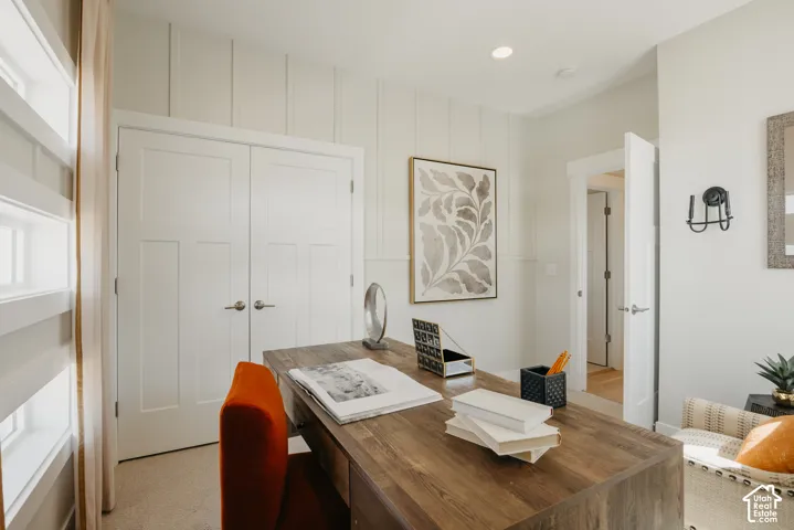 Board-and-batten wall detailing, double shaker-style closet doors, recessed lighting, and wall-mounted sconce lighting