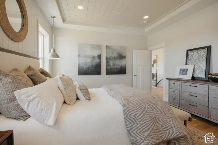 Tray ceiling with beadboard detailing, recessed lighting, vertical wall paneling, and wood-finish flooring