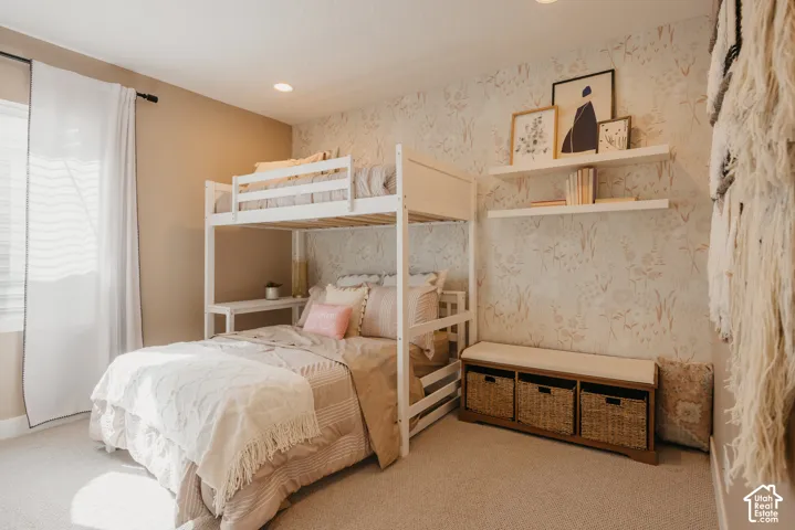 Room featuring floral patterned wallpaper, recessed lighting, and two wall-mounted floating shelves
