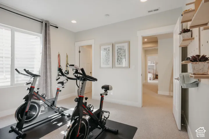Neutral-toned walls, recessed lighting, wall-mounted shelving, and windowed egress