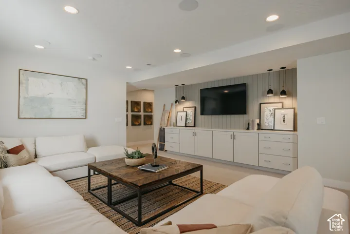 Custom built-in cabinetry with vertical paneling detail, recessed lighting, and integrated pendant light fixtures