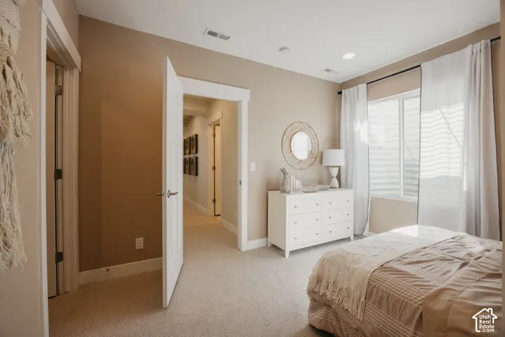 Neutral-toned interior featuring wall-to-wall carpeting, recessed ceiling lighting, and crisp white door trim