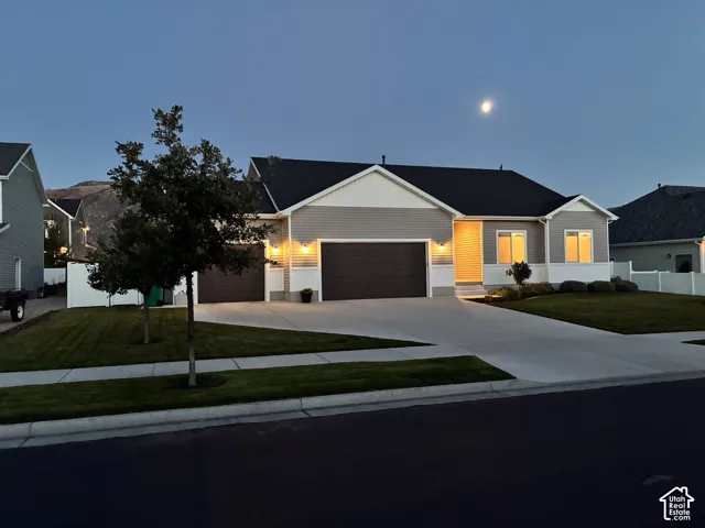 Single-story residence featuring horizontal lap siding, a concrete driveway, a three-car garage, and a gabled roofline