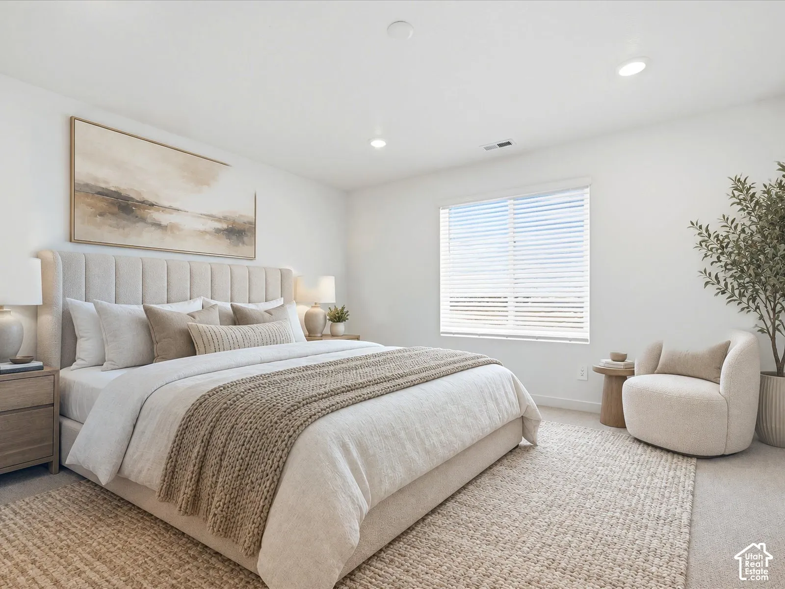 Neutral-toned carpeted flooring, recessed ceiling lighting, and a large window with horizontal blinds