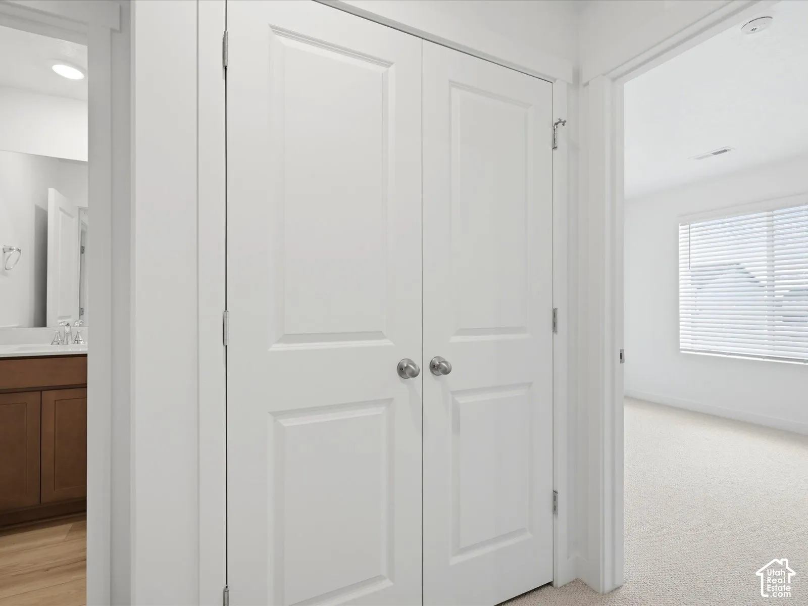 **DISCLAIMER** Interior package may vary. Double-panel interior doors with brushed nickel hardware, neutral carpeting, and a window with horizontal blinds