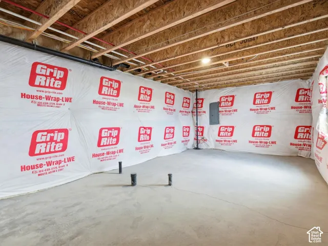 Unfinished lower level featuring exposed wood-joist ceiling, concrete flooring, and plumbing rough-ins