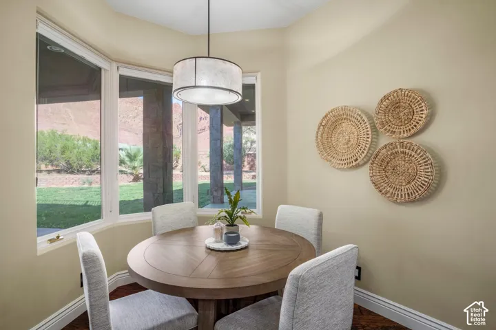 Bay window featuring expansive glazing, neutral wall tones, wood-finish flooring, and a contemporary drum pendant light fixture