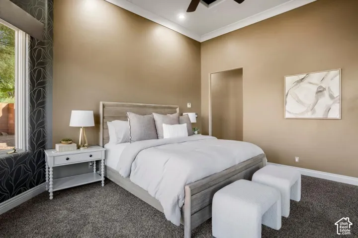 High ceilings with crown molding, patterned wallpaper accent wall, and recessed lighting