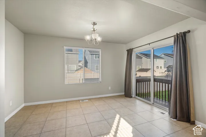 Ceramic tile flooring, multi-light ceiling fixture, single-hung window, and glass sliding door