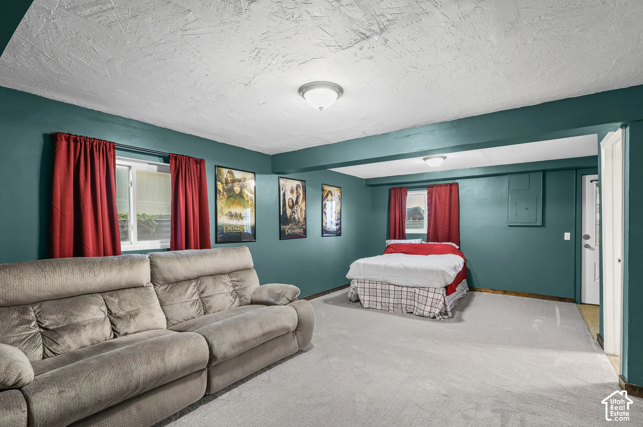 Spacious room featuring wall-to-wall carpeting, dual flush-mount ceiling light fixtures, and dual-pane windows