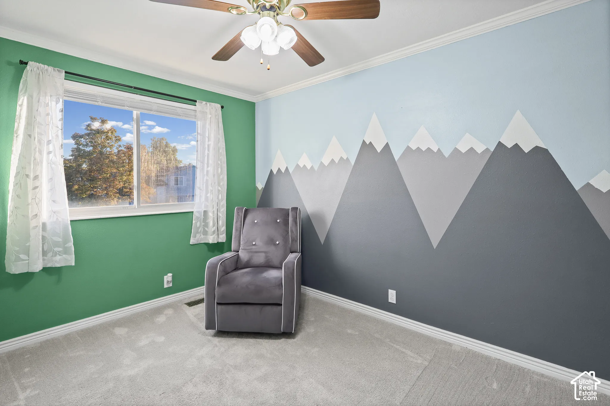 Bedroom with neutral carpeting, crown molding, and a ceiling fan with integrated lighting