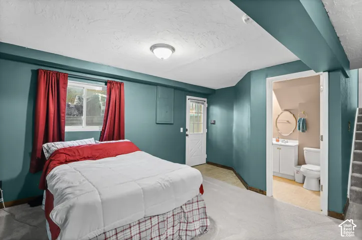 Carpeted room featuring a window, an exterior door, and built-in lighting