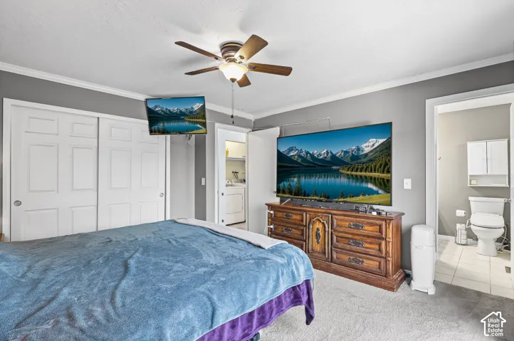 Main bedroom featuring neutral wall tones, a ceiling-mounted light fixture with integrated fan, and sliding closet doors